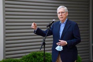 Mitch Mcconnell Delivering An Outdoor Speech Wallpaper