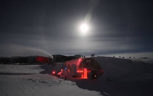 Moonlight Over A Tent In Antarctica Wallpaper