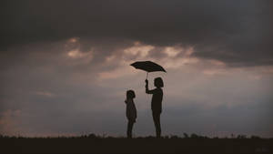 Mother And Daughter With Umbrella Wallpaper
