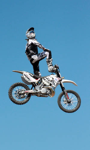 Motocross Rider Kneeling Jump Wallpaper