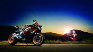 Motorcycleand Riderat Sunset Wallpaper