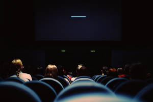 Movie Theater With People Wallpaper