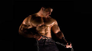 Muscle Man Pulling Heavy Chain Wallpaper