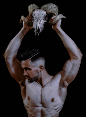 Muscular Man With Animal Skull Wallpaper