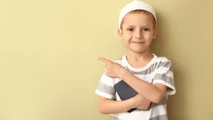 Muslim Boy Pointing The Other Side Wallpaper