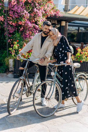 Muslim Couple With Bicycles Wallpaper