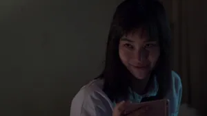 Nanno Smiling With Phone Wallpaper