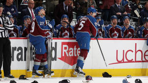 Nathan Mackinnon With Teammates In Intense Discussion During Game Wallpaper