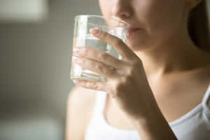 Nauseous Woman With Water Up-close Wallpaper