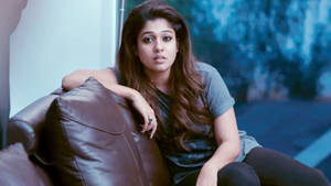 Nayanthara Lounging In Style On A Rich Brown Couch. Wallpaper