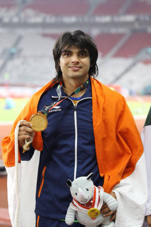 Neeraj Chopra With Flag On Shoulders Wallpaper