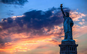 New York Hd Liberty Statue Against Sunset Wallpaper
