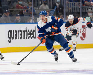 New York Islanders Ice Hockey Player Mathew Barzal In Action Wallpaper