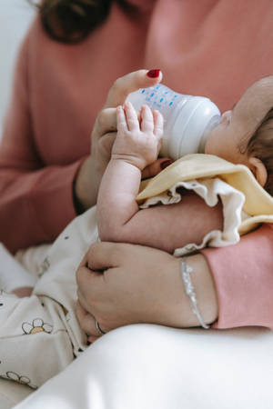 Newborn Baby Girl Bottle Fed Wallpaper