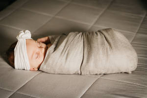 Newborn Baby Girl Sleep Swaddled Wallpaper