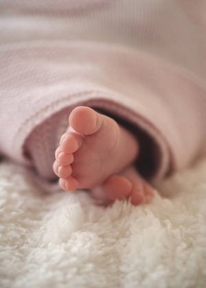 Newborn Baby Girl Swaddled Wallpaper
