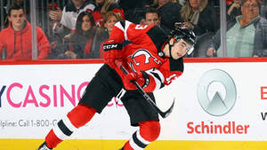 Nico Hischier Playing In Rink Wallpaper