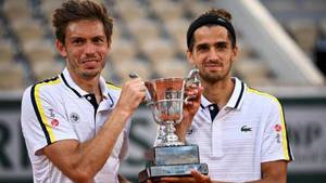 Nicolas Mahut Holding The French Open Trophy Triumphantly Wallpaper