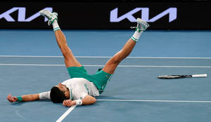 Novak Laying On Australian Open Court Wallpaper