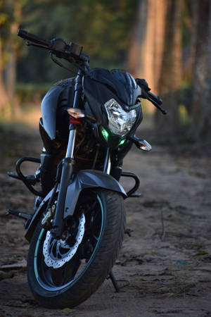 Ns 200 Black Motorcycle On Forest Ground Wallpaper