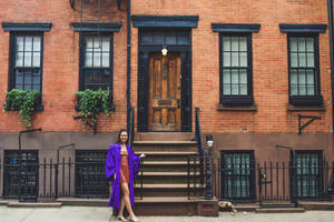 Nyu Graduate In Front Of Building Wallpaper