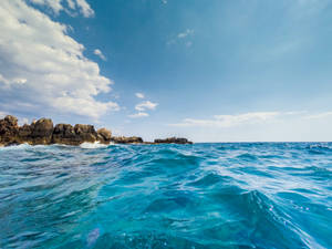 Ocean Blue Waters And Big Rocks Wallpaper