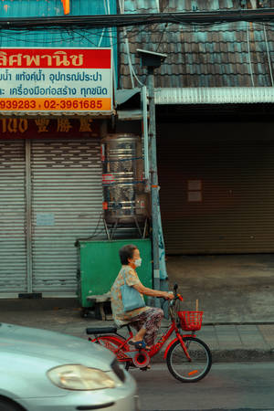 Old Woman Riding Red Bike Wallpaper