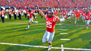 Ole Miss Player Running On Field Wallpaper