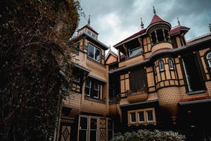 Ominous Winchester Mystery House Exterior Wallpaper