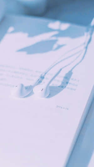 Open Book With Earphones Aesthetic Light Blue Wallpaper