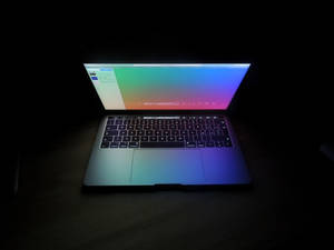 Open Laptop Captured On Dark Screen Wallpaper