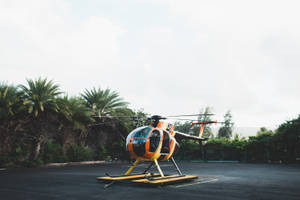 Orange And Yellow Helicopter On Ground Wallpaper