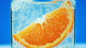 Orange Fruit In Ice Wallpaper