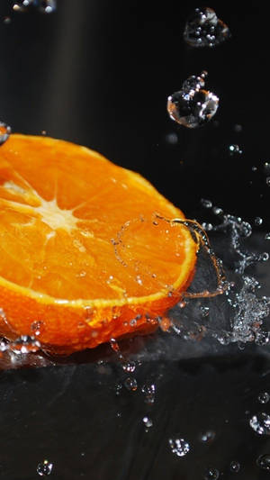 Orange Fruit With Water Splashes Wallpaper