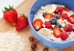 Organic Oatmeal Porridge Garnished With Fresh Berries Wallpaper