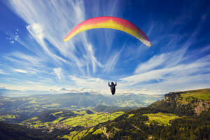 Paragliding Above Cliffs And Valleys Wallpaper