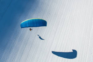 Paragliding Above Snow Wallpaper