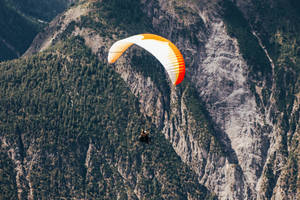 Paragliding Above Steep Mountain Wallpaper