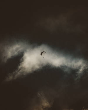 Paragliding Against Dark Sky Wallpaper