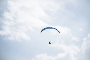 Paragliding Pilot Amongst The Clouds Wallpaper