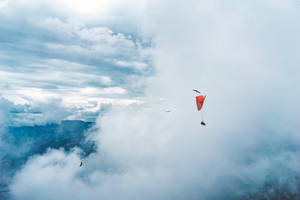 Paragliding Through Clouds Wallpaper