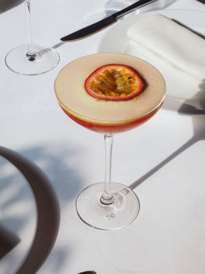 Passion Fruit Martini In Wine Glass Wallpaper