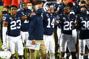 Penn State Football Players Standing On The Field Wallpaper