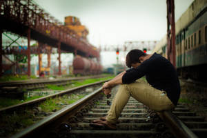 Pensive Sad Boi Pondering On Train Tracks Wallpaper