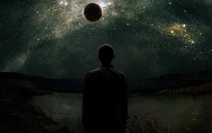 Person Gazing Black Planet Wallpaper