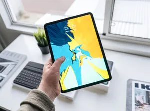 Person Holding Apple Ipad Pro Wallpaper