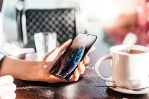 Person Holding Phone Lock Screen Wallpaper