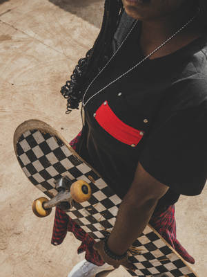Person With Checkered Skateboard Wallpaper
