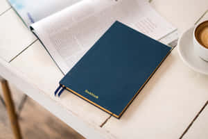 Personal Planner On A Desk With Essentials Wallpaper