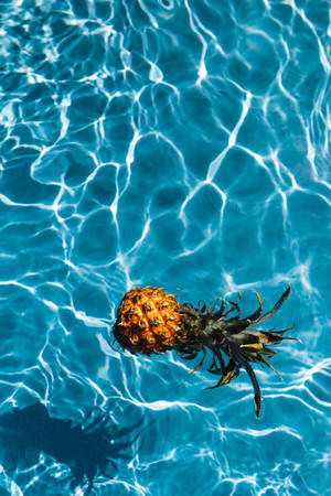 Pineapple Floating On Water Wallpaper